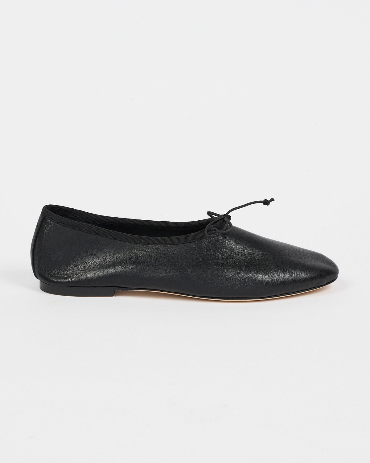 Jamie Haller High Vamp Ballet in black with an elongated shape and elastic bow tie.