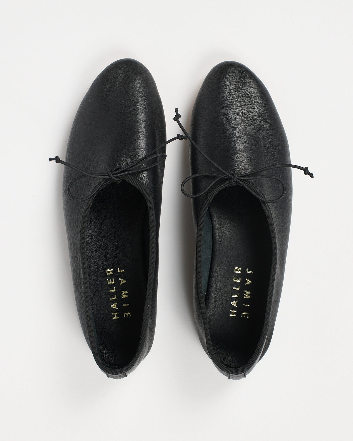 Jamie Haller High Vamp Ballet in black with an elongated shape and elastic bow tie.