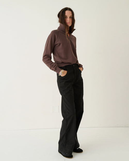 Model wearing Jamie Haller The Quarter Zip in brown Japanese French terry with a stand collar, quarter-zip front, and relaxed fit.