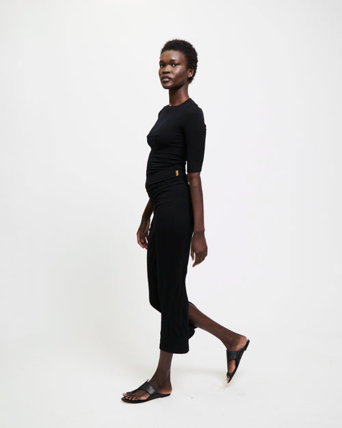 Model wearing The Rib Pencil Skirt in Black by Jamie Haller.