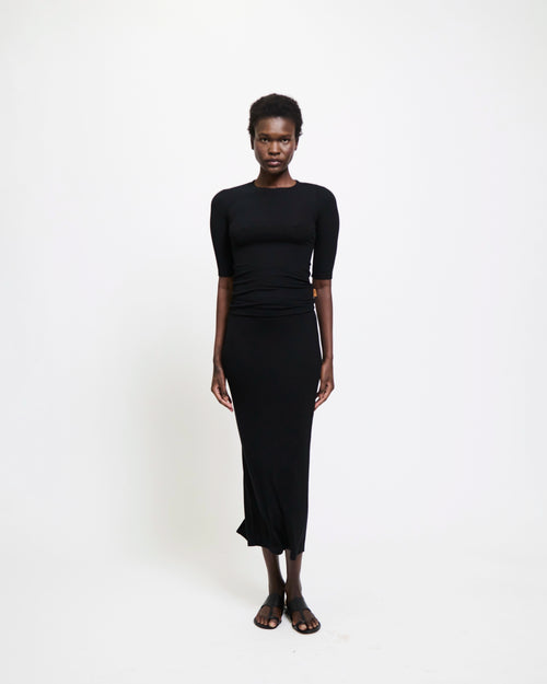 Model wearing The Rib Pencil Skirt in Black by Jamie Haller.