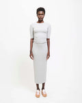 Model wearing Jamie Haller Rib Pencil Skirt in heather grey with a slim, straight silhouette and ankle-length hem.