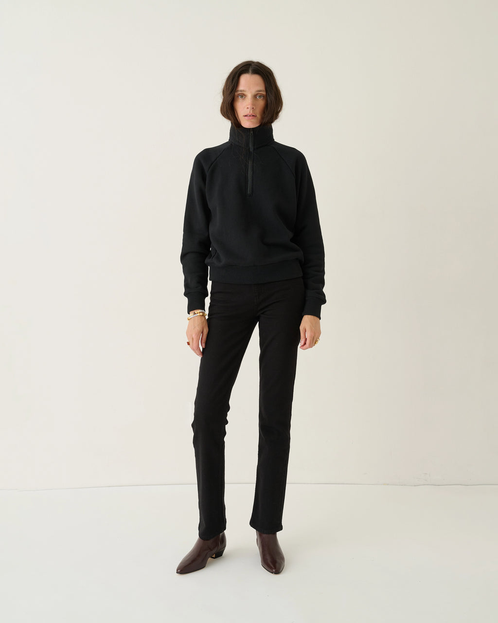 Model wearing Jamie Haller Slim Stovepipe Jean in black with a slim, full-length silhouette.
