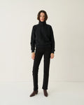 Model wearing Jamie Haller Slim Stovepipe Jean in black with a slim, full-length silhouette.