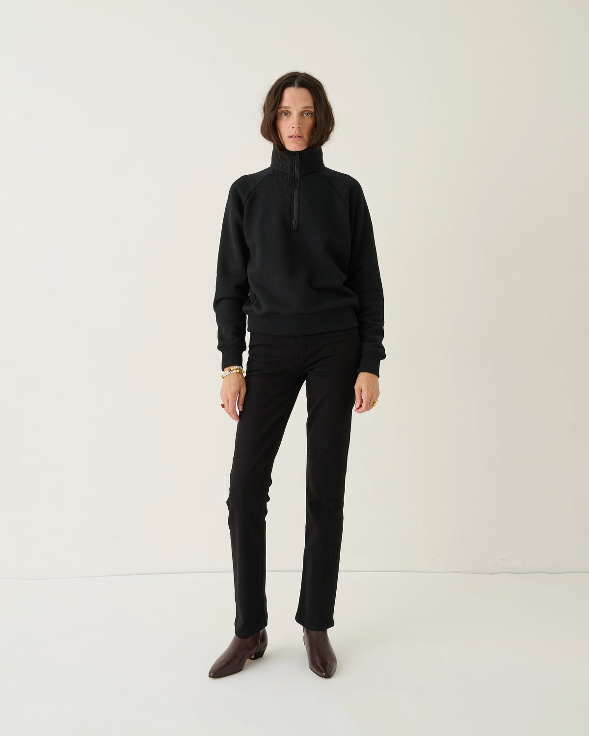Model wearing Jamie Haller Slim Stovepipe Jean in black with a slim, full-length silhouette.