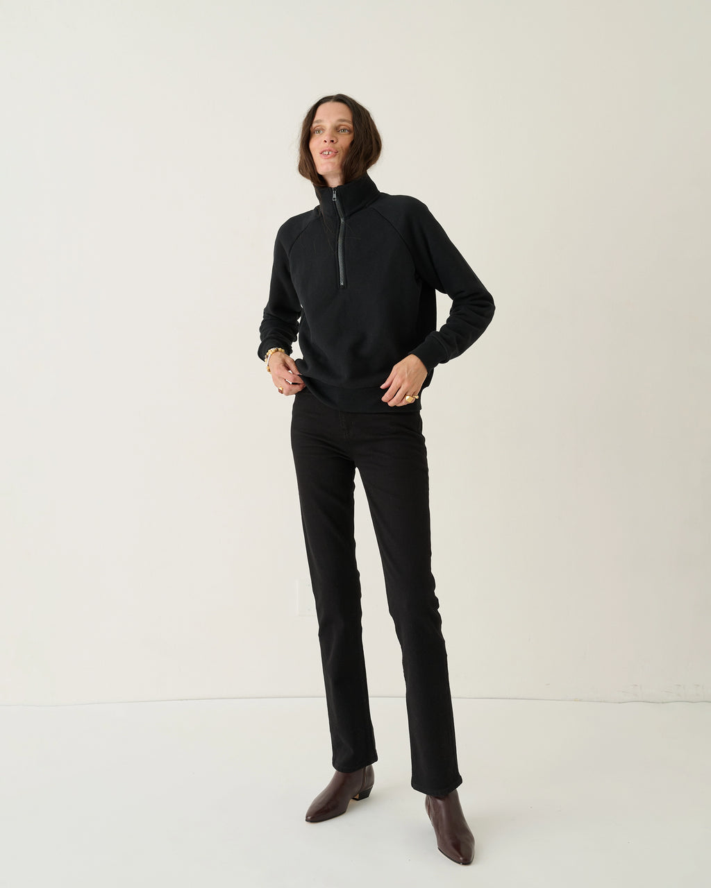 Model wearing Jamie Haller Slim Stovepipe Jean in black with a slim, full-length silhouette.