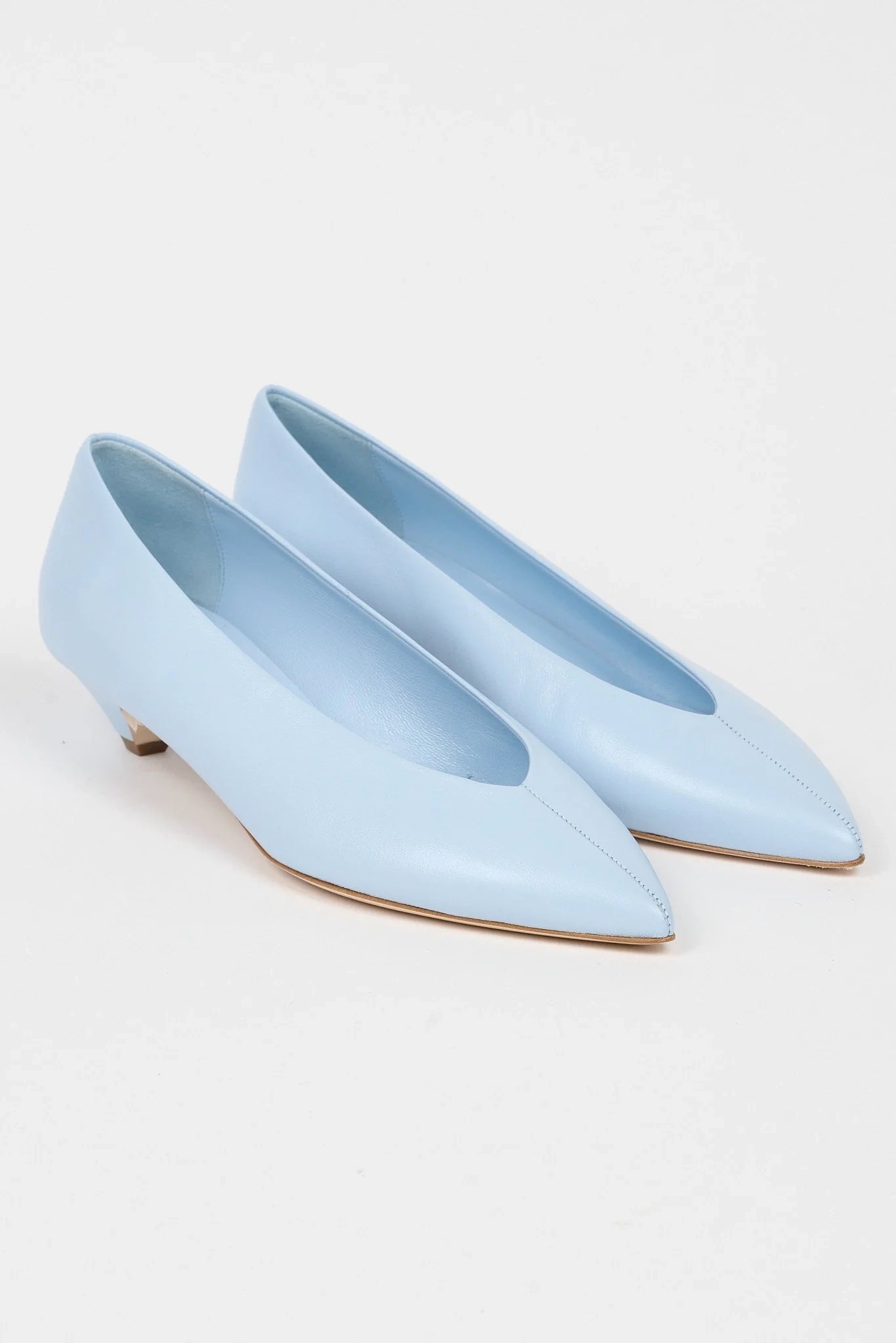 Jamie Haller light blue leather pump with a soft pointed toe, enclosed silhouette and low trapezoidal heel.