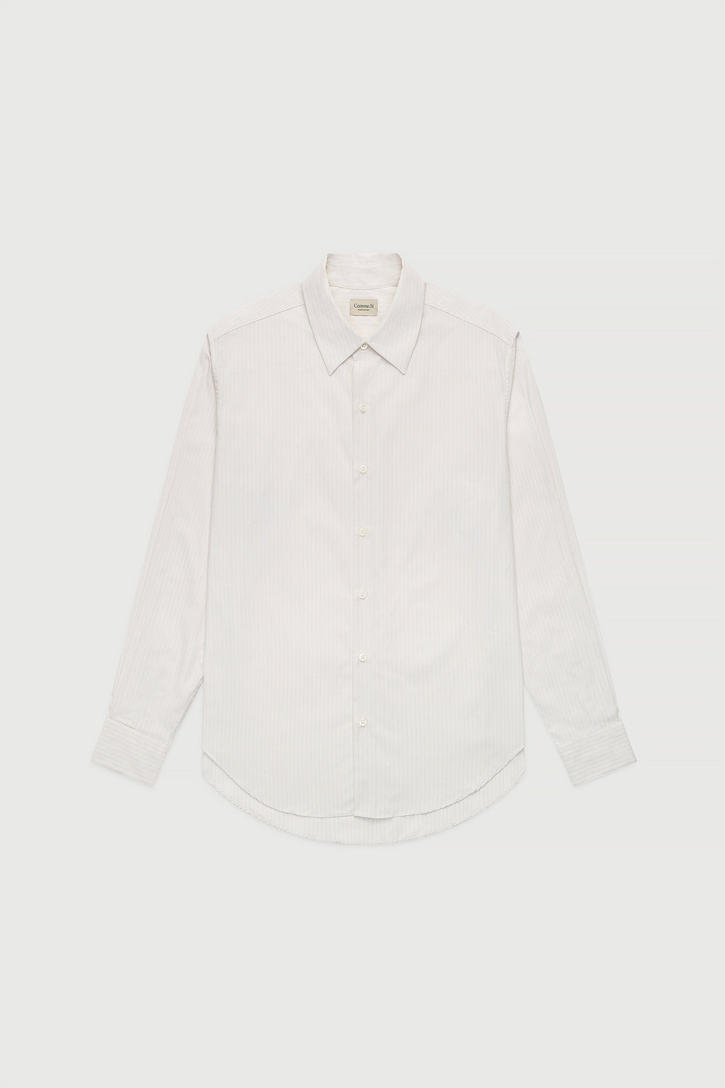 A white, long-sleeved, button-up shirt with a collar, made of cotton poplin fabric.