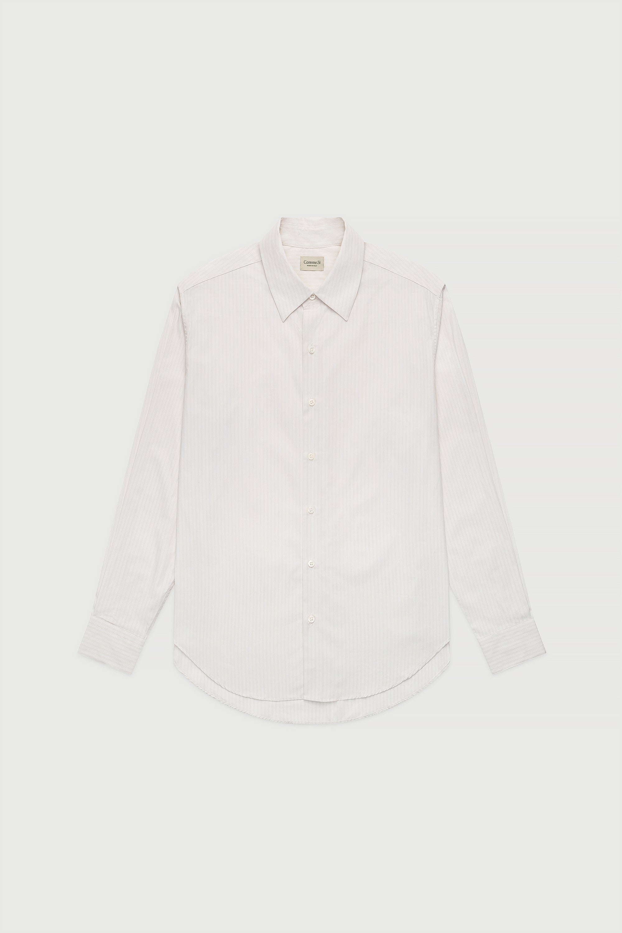 A white, long-sleeved, button-up shirt with a collar, made of cotton poplin fabric.
