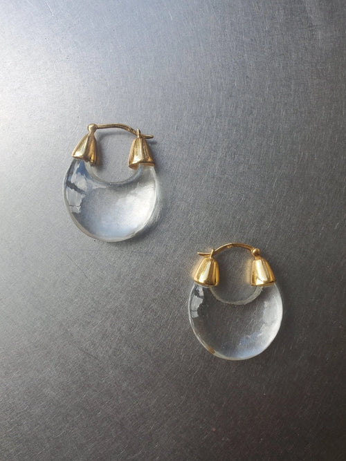NOMIA crystal hoop earrings with carved teardrop crystal drops and gold vermeil hinged hoops.