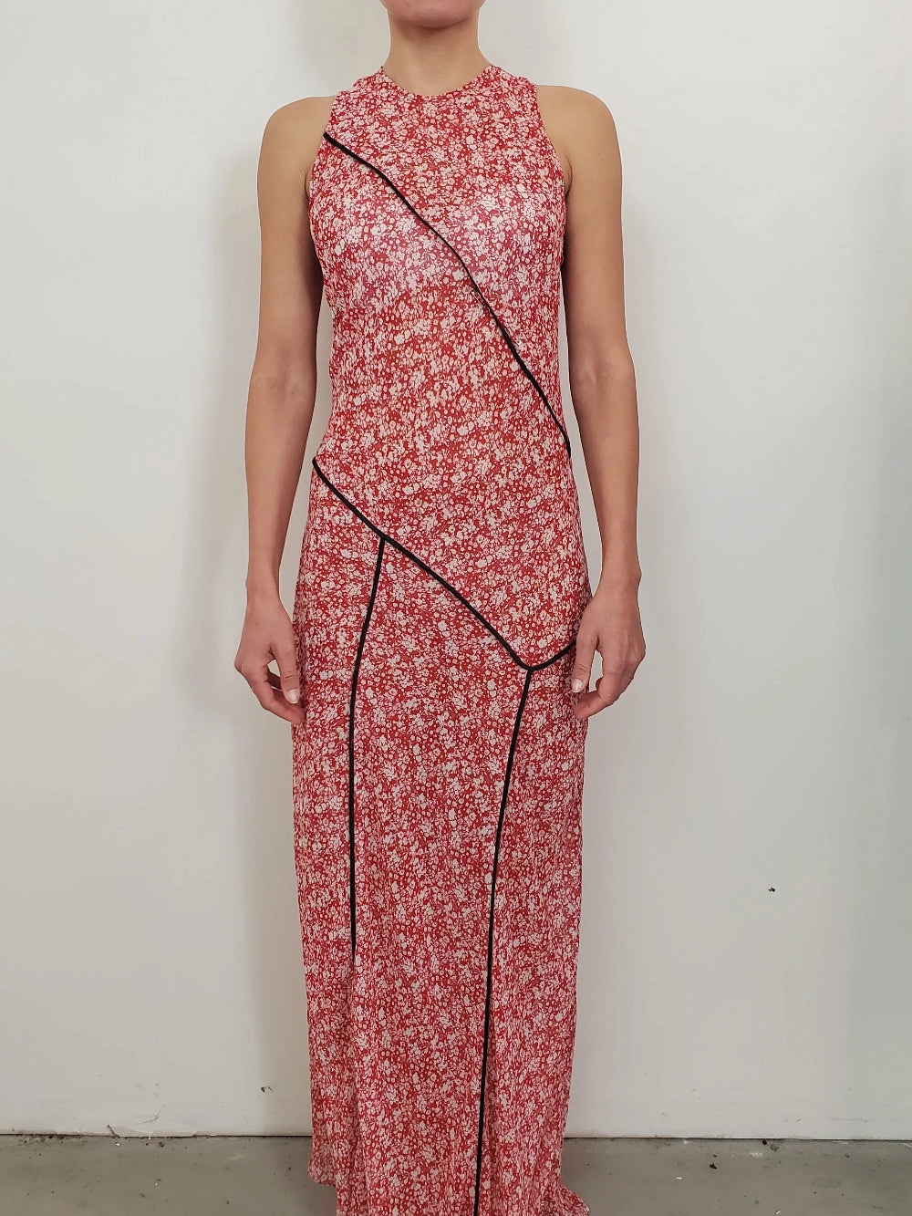 NOMIA paneled maxi bias dress in poppy floral chiffon with contrast piping, fitted through the bodice with a fluid full-length skirt and asymmetric hem.