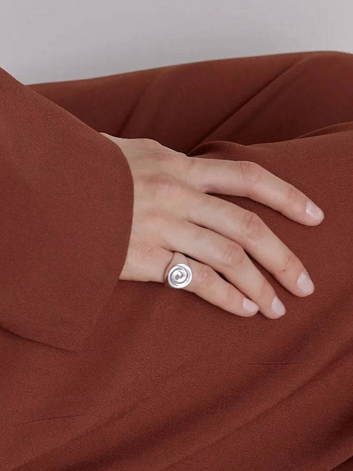 NOMIA Spiral Signet Ring worn on hand.