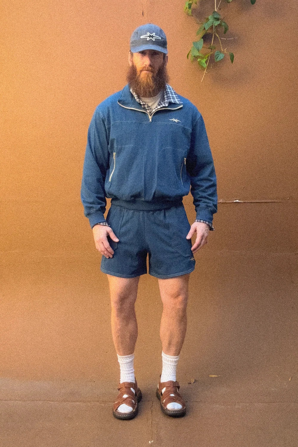 Model wearing PHIPPS Bunkhouse Quarter Zip and Vacation Dad Short in Dusk Blue.