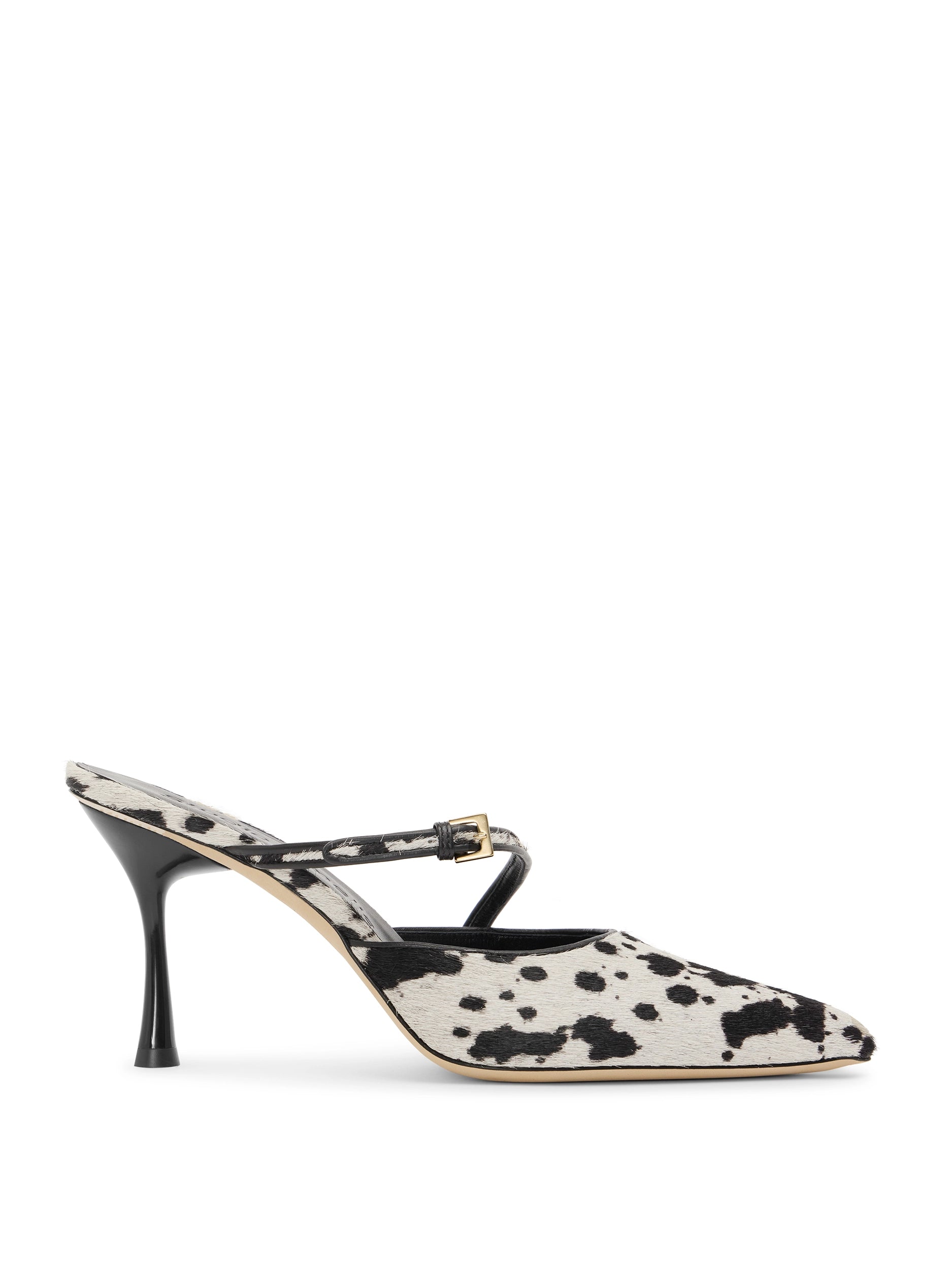 High-heeled shoe with black and white cow print on a white background