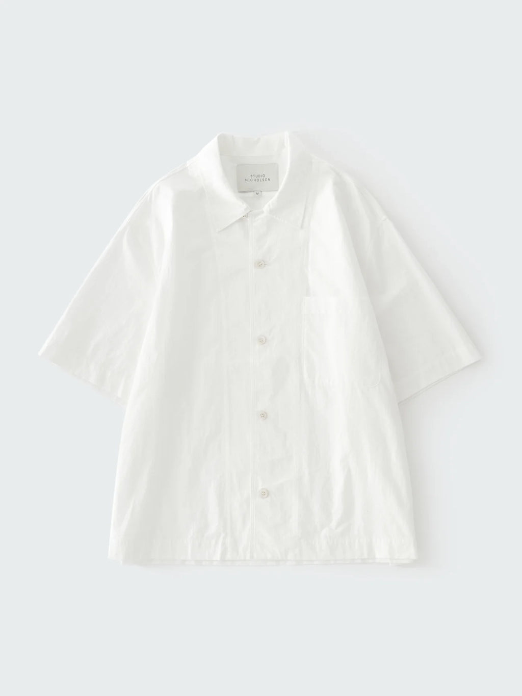 White polo shirt on a light gray background