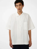 Person wearing a white short-sleeve shirt on a white background