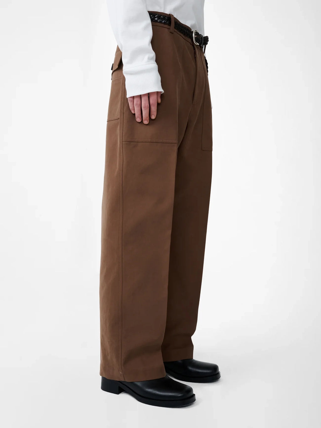 Brown pants worn by a person on a white background