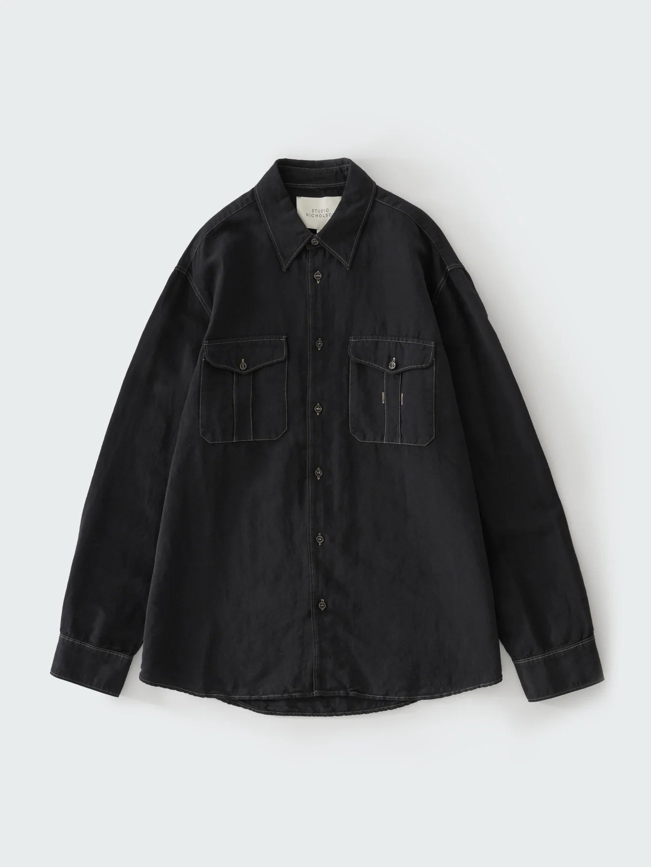 Black shirt with two front pockets on a white background