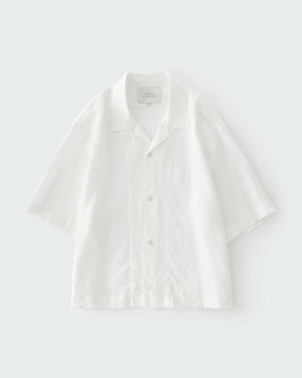 Studio Nicholson Oryn white linen short sleeve shirt with a camp collar and straight hem.