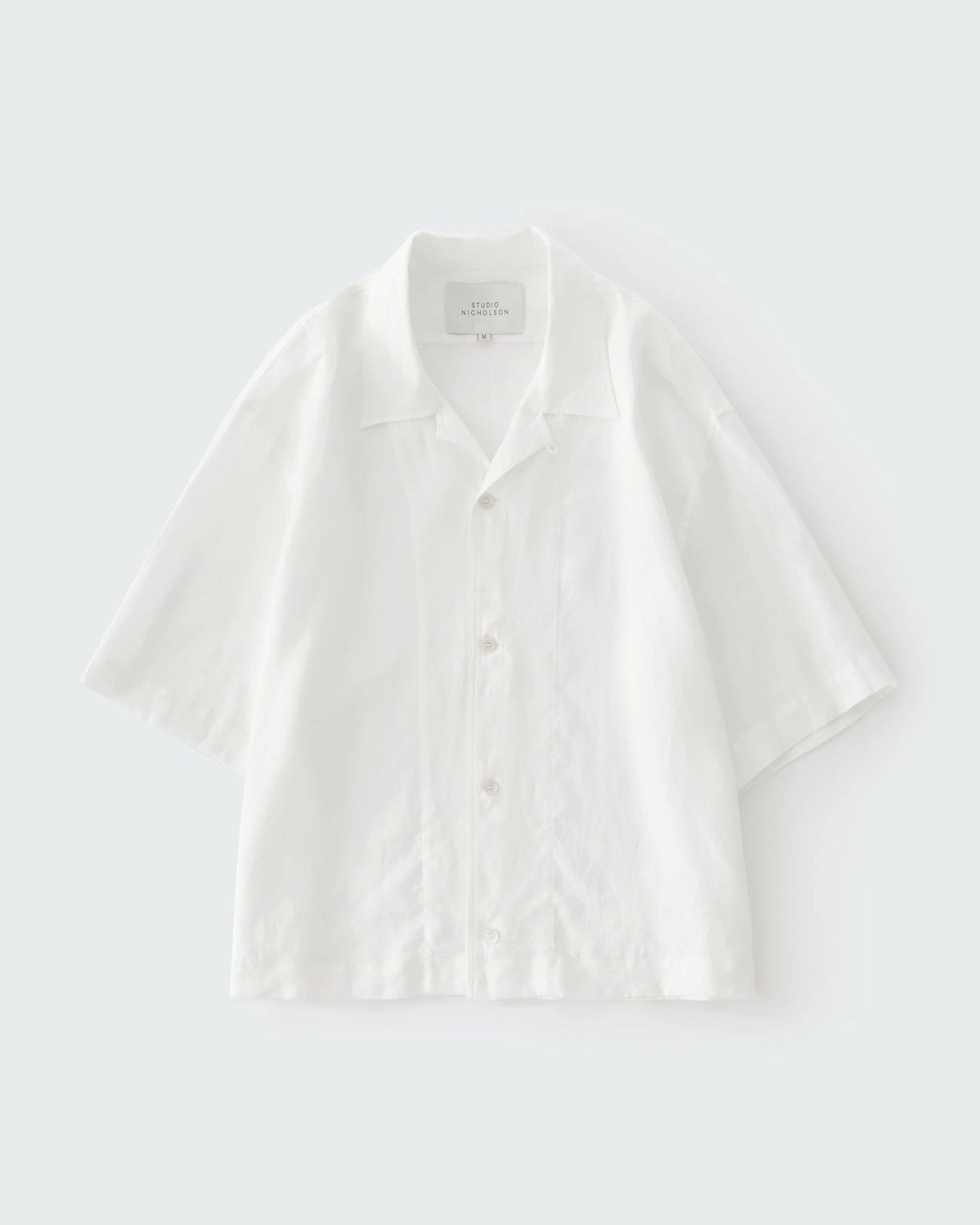 Studio Nicholson Oryn white linen short sleeve shirt with a camp collar and straight hem.