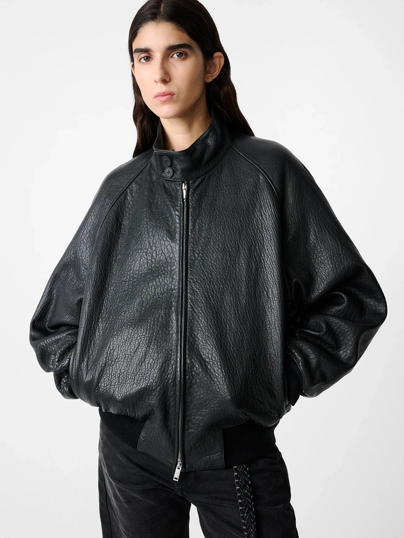 Person wearing a black leather jacket on a white background