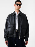 Person wearing a black leather jacket and sunglasses on a white background