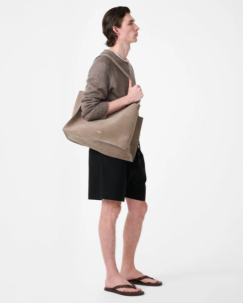 Model wearing Studio Nicholson Starboard black textured wool-cotton drawstring shorts with slip pockets and a back flap pocket.