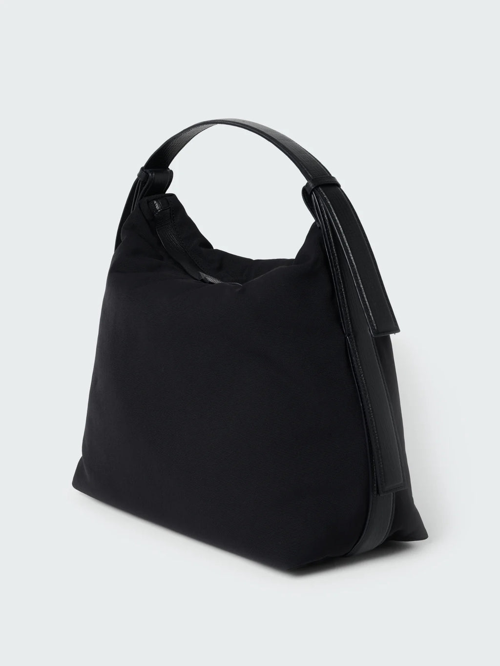 Black handbag on a light gray background