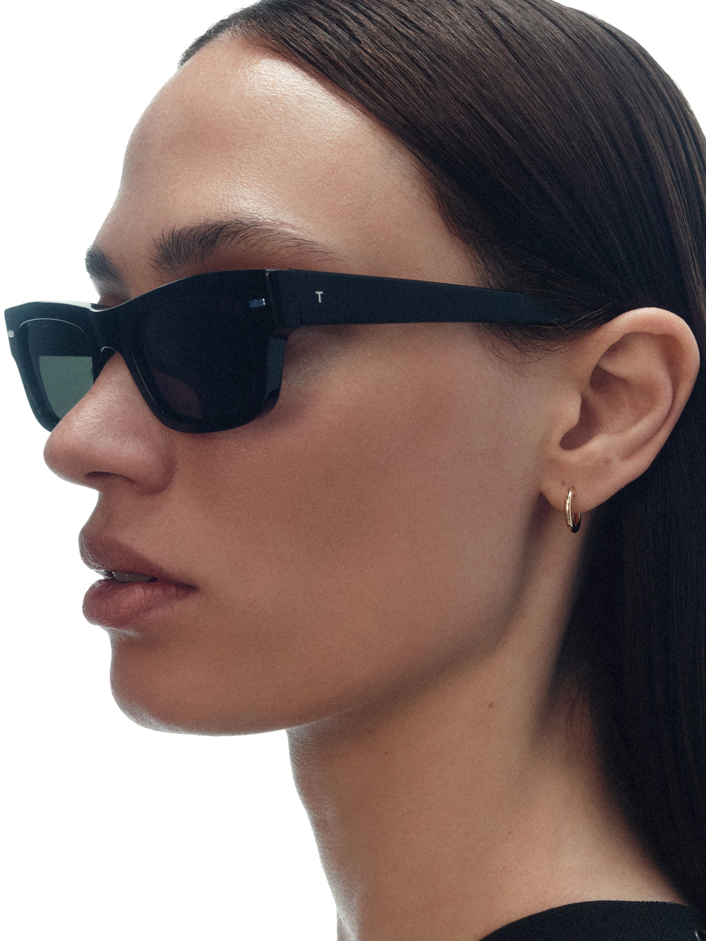 Model wearing THISTLES JACK sunglasses in black acetate with an angular wayfarer-inspired silhouette and dark green G15 lenses.