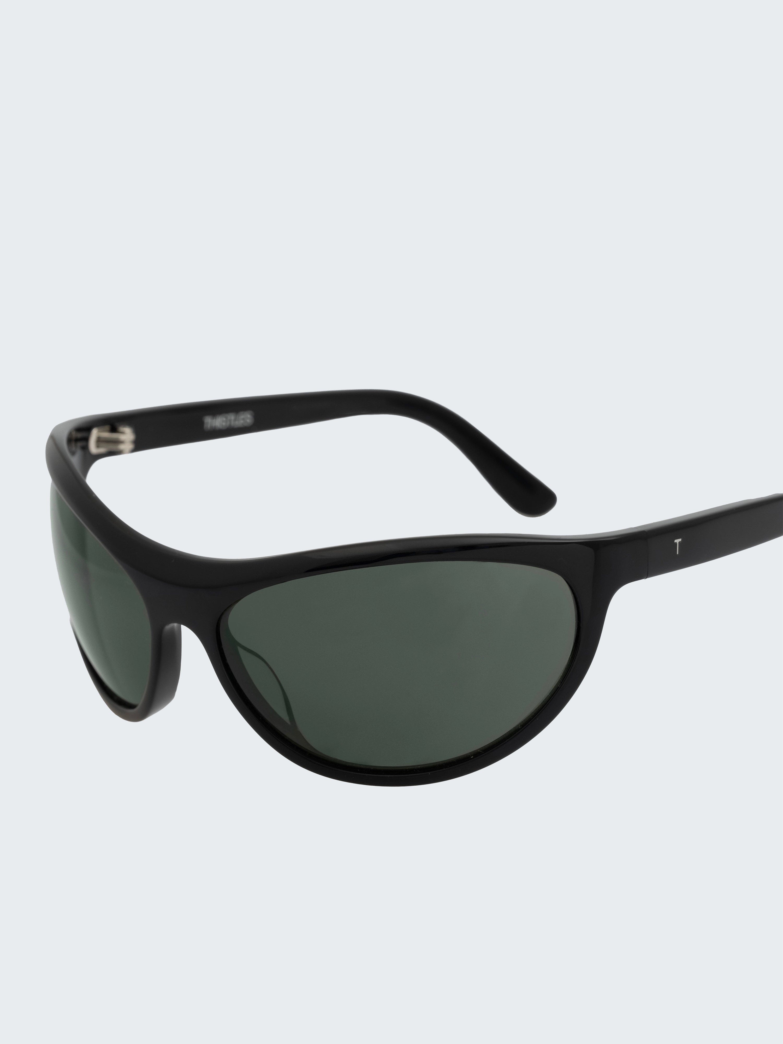 THISTLES LEX sunglasses in black acetate with a narrow wrap silhouette and dark green G15 lenses.