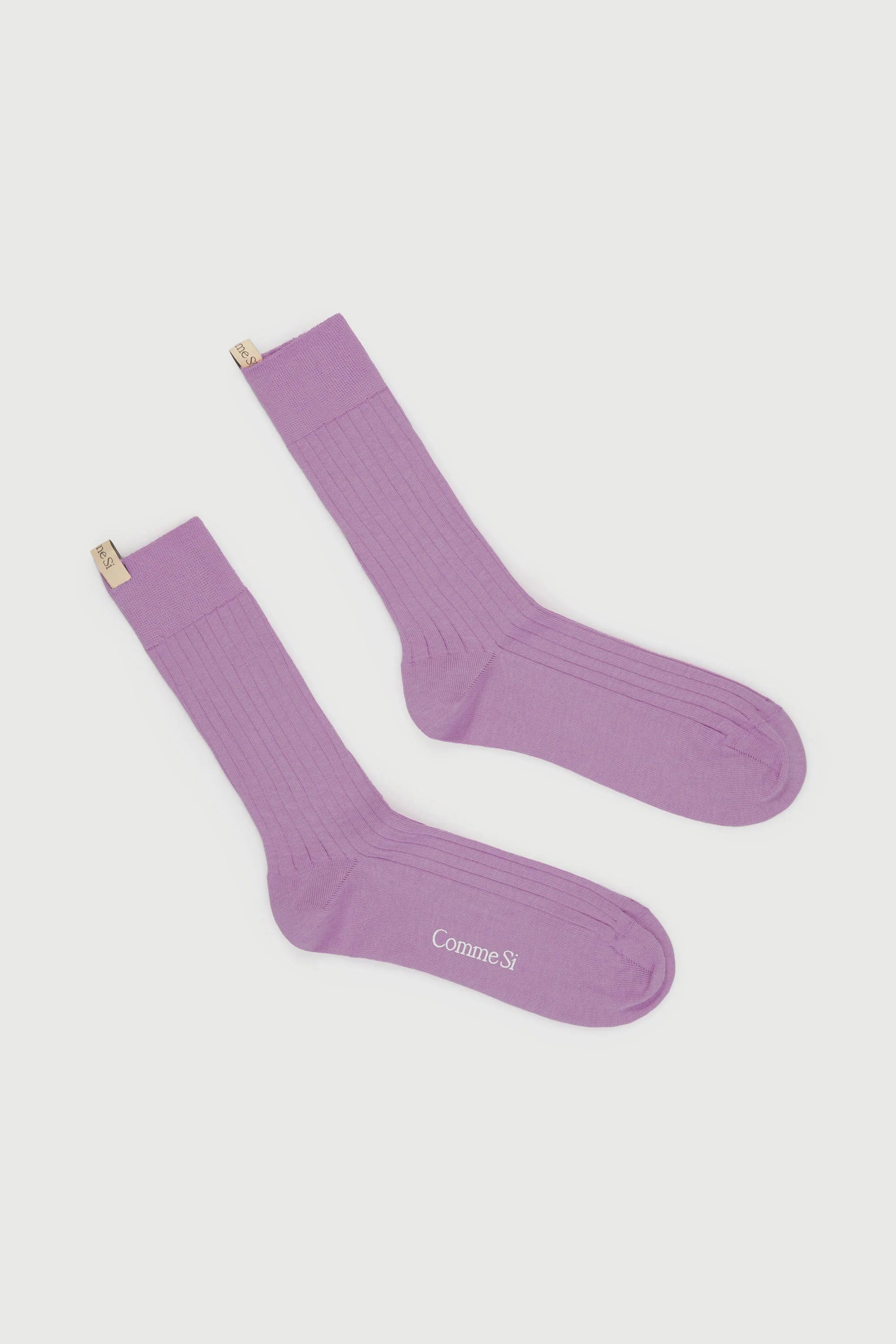A pair of purple long socks with a wide rib and reinforced toe, branded with 'comme si' on the ankle area.